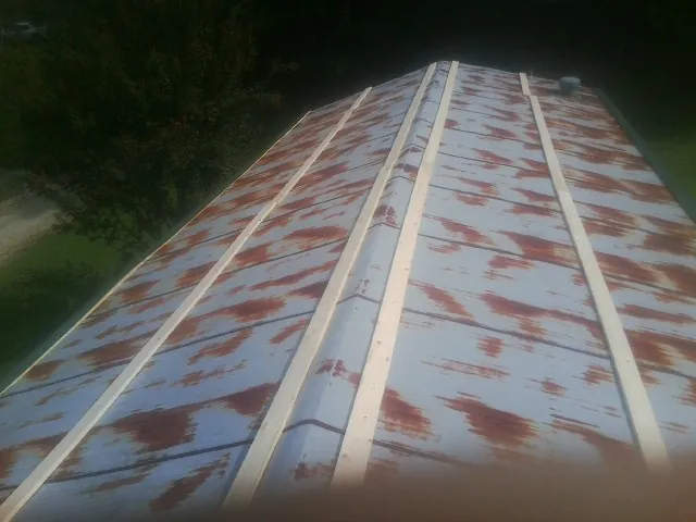 Rusted metal roof panels with new wood purlins before replacement — Storm Damage Roof Repair in Bellona by Roofing Brothers